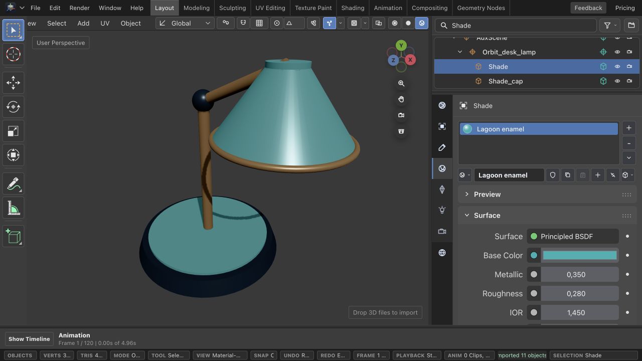 Orbit desk lamp in the browser 3D editor, with its teal shade selected and Base Color, Metallic, and Roughness material controls visible.