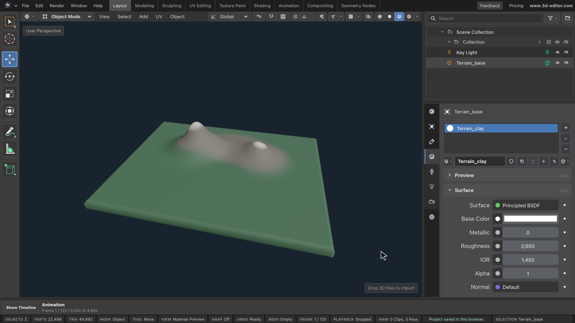 A sculpted miniature landscape in the online 3D editor, with green lowlands, a rocky ridge, and two pale summits.